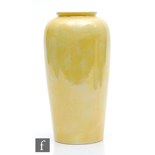 85 - Ruskin Pottery - A vase of tapering barrel form decorated in a yellow lustre, impressed mark and dat... 