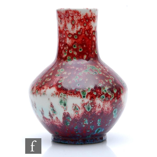 89 - Ruskin Pottery - A high fired vase of angular globe and shaft form decorated in a sang de beouf with... 