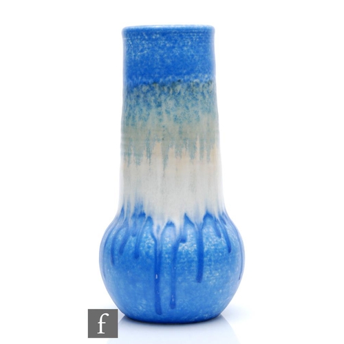 97 - Ruskin Pottery - A large crystalline glaze vase with shaped neck decorated in a mottled blue over wh... 