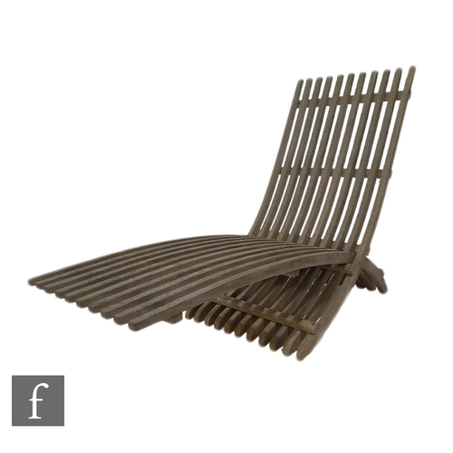 1372 - Skargaarden - A folding slatted teak Nozib outdoor lounger of cantilever design, in a weathered cond... 