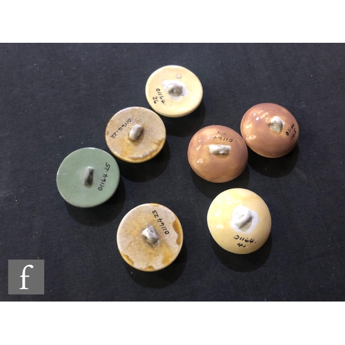 238 - William Moorcroft - Seven assorted buttons comprising four flat and three domed, glazed in yellow, g... 