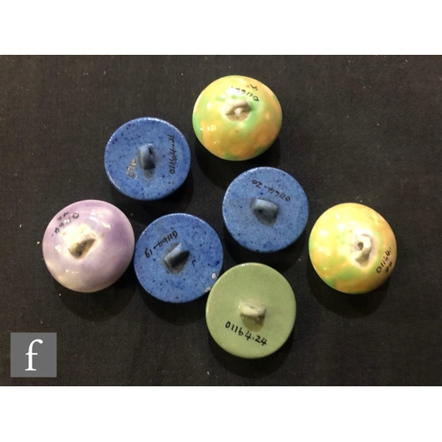 242 - William Moorcroft - Seven assorted buttons comprising three in powder blue, two in apple green, one ... 