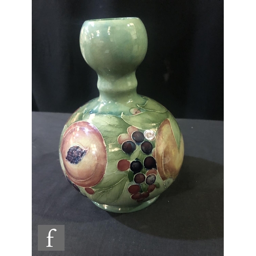 166 - William Moorcroft - A double gourd vase decorated in the Pomegranate pattern with a band of open and... 