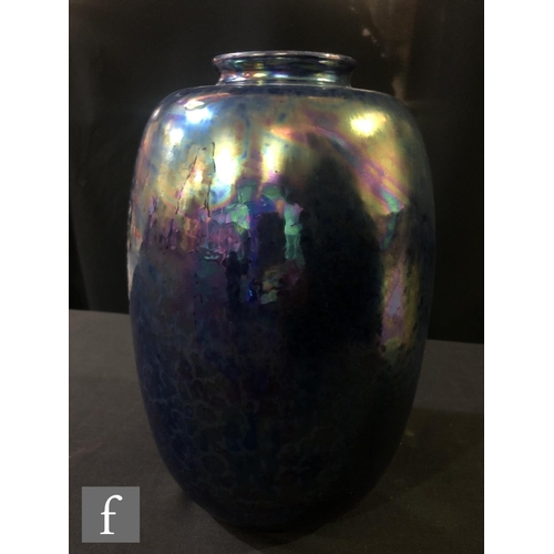 79 - Ruskin Pottery - A large vase of swollen form decorated in an all over Kingfisher Blue lustre, impre... 