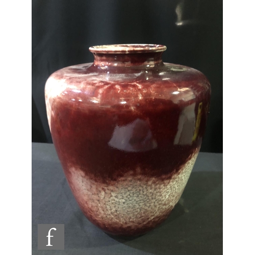 98 - Ruskin Pottery - A large high fired vase of shouldered form decorated in a sang de beouf with fissur... 