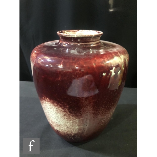 98 - Ruskin Pottery - A large high fired vase of shouldered form decorated in a sang de beouf with fissur... 