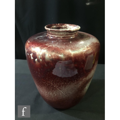 98 - Ruskin Pottery - A large high fired vase of shouldered form decorated in a sang de beouf with fissur... 