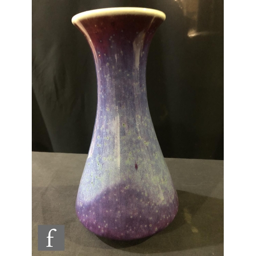 103 - Ruskin Pottery - A high fired vase of flared form decorated in a tonal lavender with paler curtain a... 