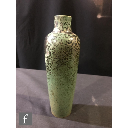 130 - Ruskin Pottery - A high fired vase of slender tapering form decorated in a tonal green with fissurin... 