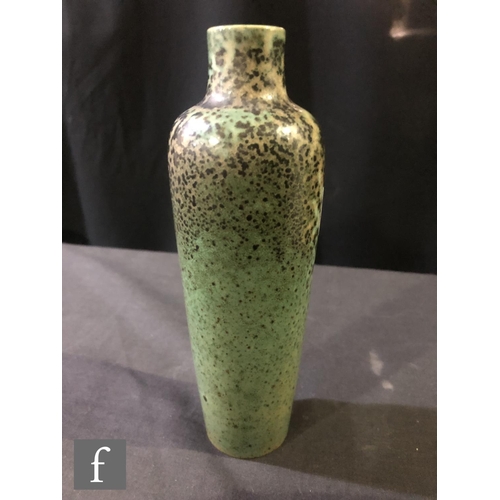 130 - Ruskin Pottery - A high fired vase of slender tapering form decorated in a tonal green with fissurin... 