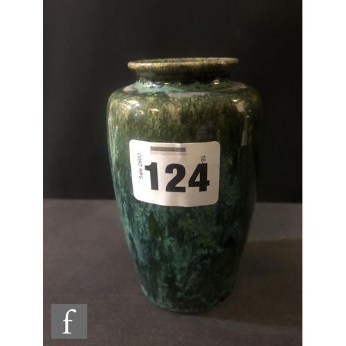 124 - Ruskin Pottery - A small souffle glazed vase of swollen form decorated in a mottled green with tonal... 