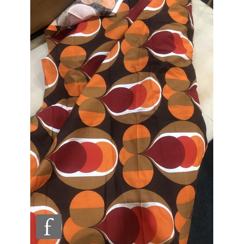 1004 - Unknown - A large roll of 1970s fabric printed with a repeat geometric pattern in shades of red, ora... 