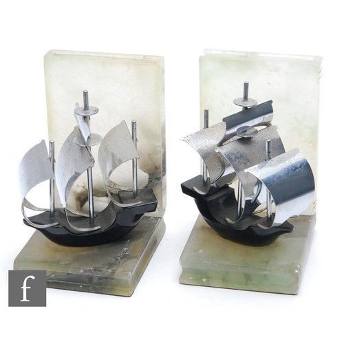 501 - A pair of 1930s Art Deco bookends, each with a stylised ship in full sail, the body enamelled in bla... 