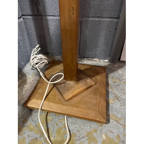 954 - Unknown - A light oak square section standard lamp, raised from a raised square plinth base to a tap... 