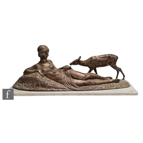 506 - A patinated bronze figure of a reclining woman feeding a deer, signed in the cast D.H. Chiparus, set... 