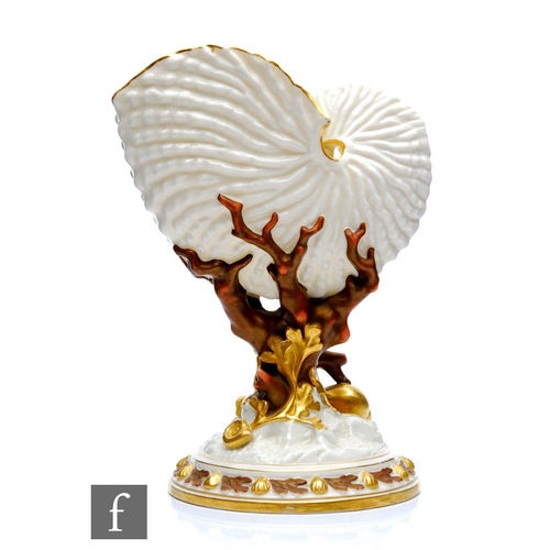 104 - A late 19th Century Royal Worcester spoon warmer or posy vase modelled as a nautilus shell, raised t... 