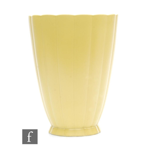 112 - A Wedgwood straw glazed vase designed by Keith Murray, of flared ribbed form, printed KM Wedgwood Et... 