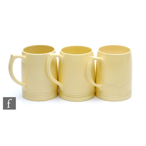 114 - Three Keith Murray for Wedgwood Matt Straw tankards with horizontal bands to the foot, printed signa... 