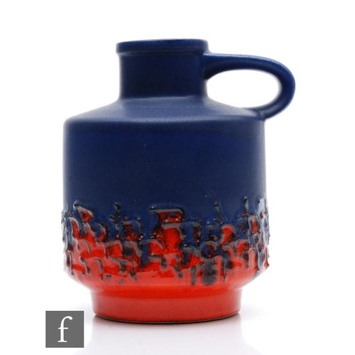 118 - A mid 20th Century German flower jug decorated in a matt royal blue to gloss red fat lava type glaze... 