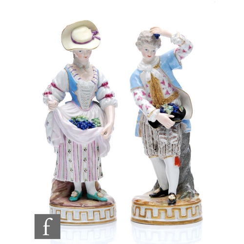 142 - A pair of 19th Century Meissen figures of winegrowers, she dressed in a blue bodice with patterned s... 