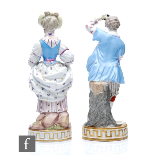 142 - A pair of 19th Century Meissen figures of winegrowers, she dressed in a blue bodice with patterned s... 