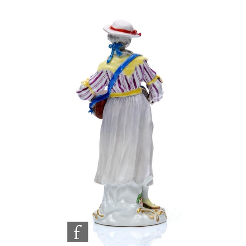 143 - A 19th Century Meissen figure of a lady stood playing a Hurdy Gurdy, dressed in a striped bodice wit... 