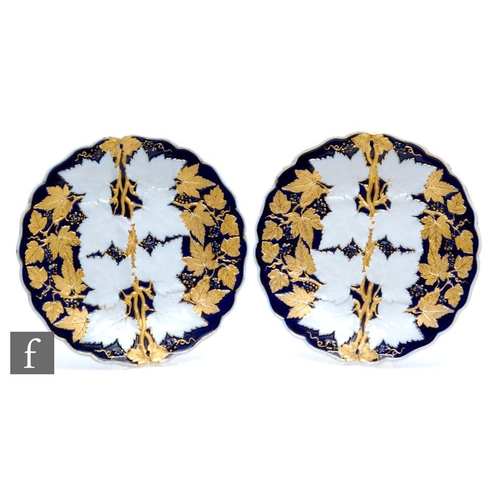 149 - Two 20th Century Meissen plates decorated in relief with leaves and berries against a royal blue gro... 