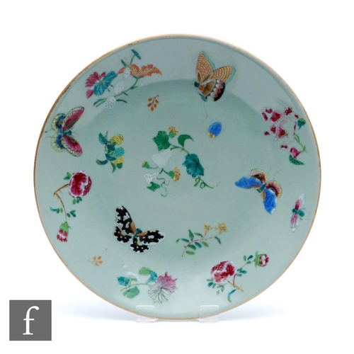 160 - A Chinese late Qing Dynasty (1644-1912) Celadon butterfly dish, the pale green ground picked out wit... 