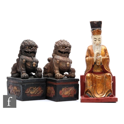 163 - A pair of Chinese carved hardwood Shishi lions, each raised on plinth bases carved with lotus, both ... 