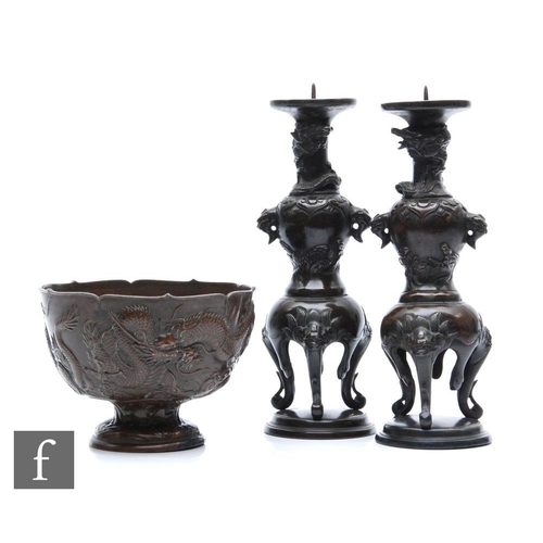 164 - A collection of Japanese metalwares, to include a pair of pricket type candlesticks, the circular ba... 