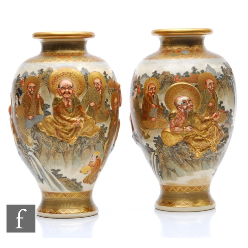 175 - A pair of Japanese Meiji (1868-1912) period satsuma vases, each relief moulded with depictions of de... 