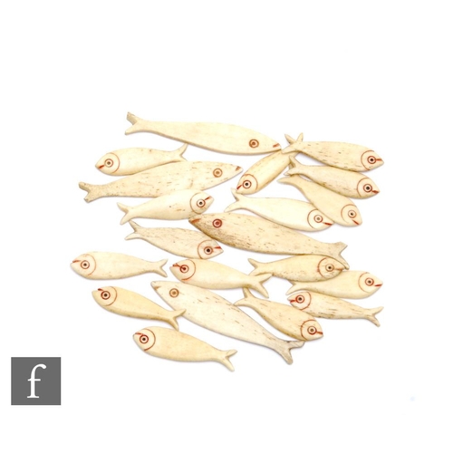 473 - A small collection of 19th Century Napoleonic bone gaming counters in the form of fish. (20)