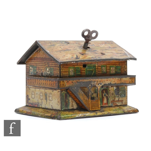 488 - An early tinplate lithographed money box, possibly American, in the form of a house with applied bal... 