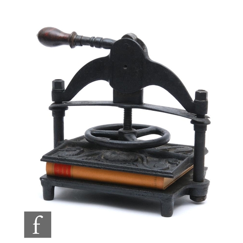 490 - A late 19th Century black painted cast iron book press by Patrick Richie Edinburgh, spoked wheel ope... 