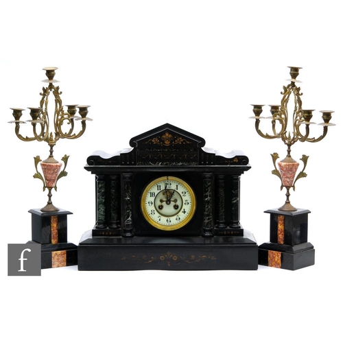 493 - A Victorian slate mantle clock of architectural form and a pair of associated gilt metal four branch... 