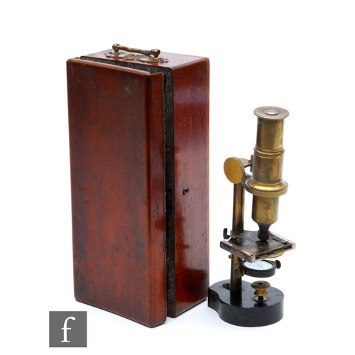 510 - A late 19th Century brass student's microscope on shaped black painted base with some slides in fitt... 