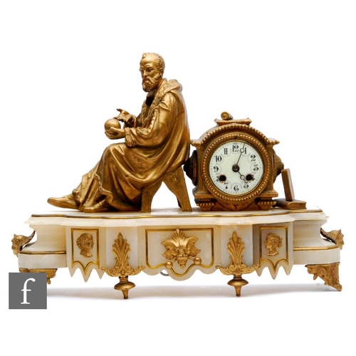 512 - A late 19th Century French gilt mantle clock, mounted with a scholar holding a sphere next to an Ara... 