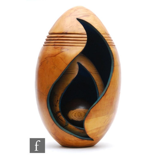 523 - A large contemporary treen sculpture, of egg form with carved ribbed decoration, fret cut sides and ... 