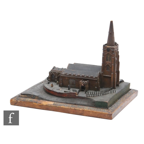 525 - A 19th Century scale wooden model of a church with steeple, on a fenced board with grave stones, wid... 