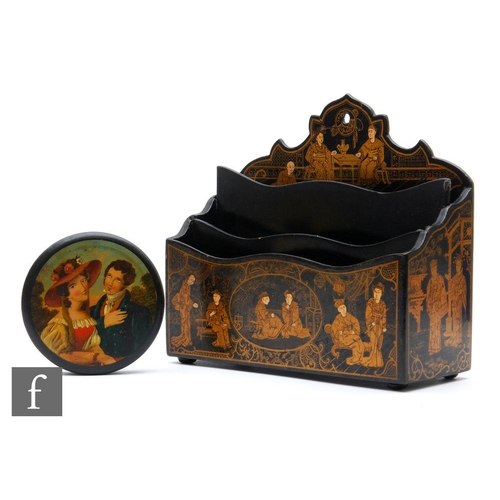 529 - A 19th Century over painted papier mache circular snuff box depicting a courting couple, width 9.5cm... 