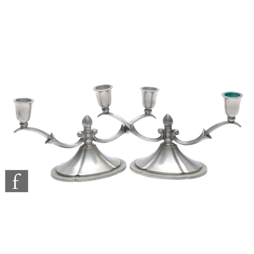 560 - A pair of 1930s Swedish pewter two light candelabra by Ceson, with domed base and lobed finials, sta... 