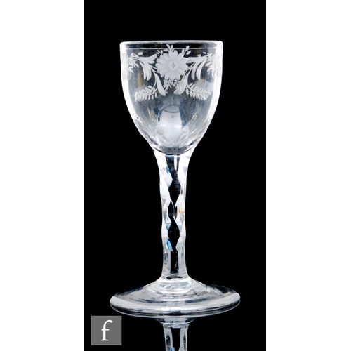 571 - An 18th Century drinking glass circa 1785, the round funnel bowl engraved with a garland of flowers ... 