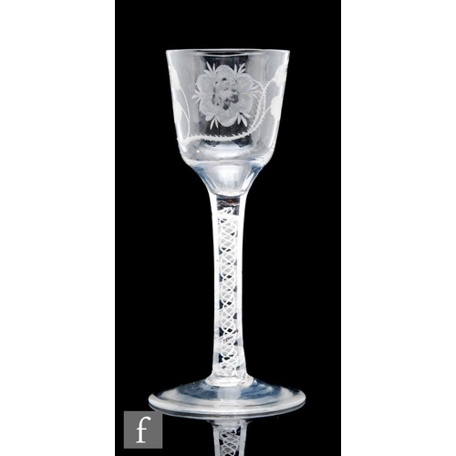 596 - An 18th Century Jacobite drinking glass circa 1765, the ogee bowl engraved with a rose and bud on le... 