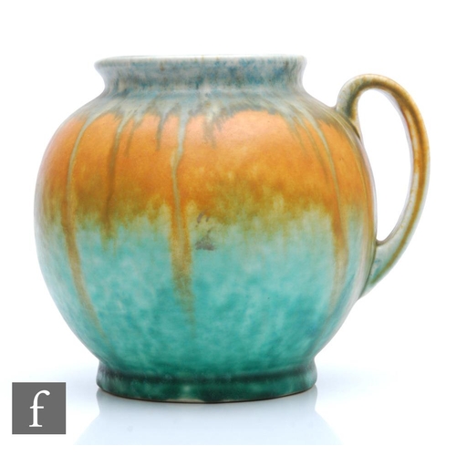 8 - A Ruskin Pottery flower jug of ovoid form with loop handle and slightly pronounced spout glazed in g... 