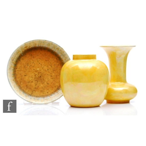 9 - Three pieces of Ruskin Pottery comprising a yellow lustre ginger jar base, damaged, a small yellow l... 