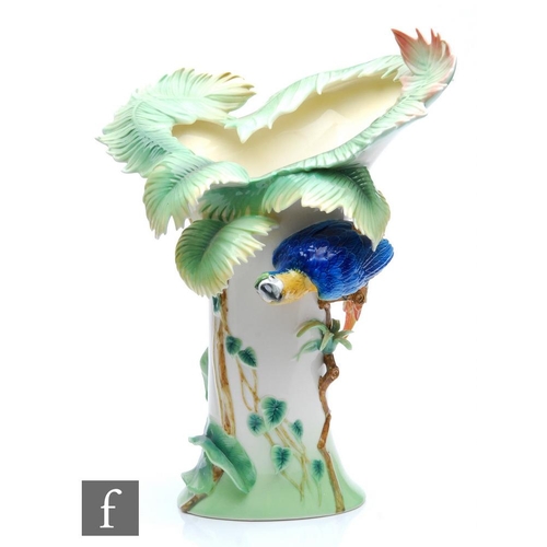 99 - A contemporary Franz porcelain limited edition vase decorated with a parrot perched on a branch, the... 