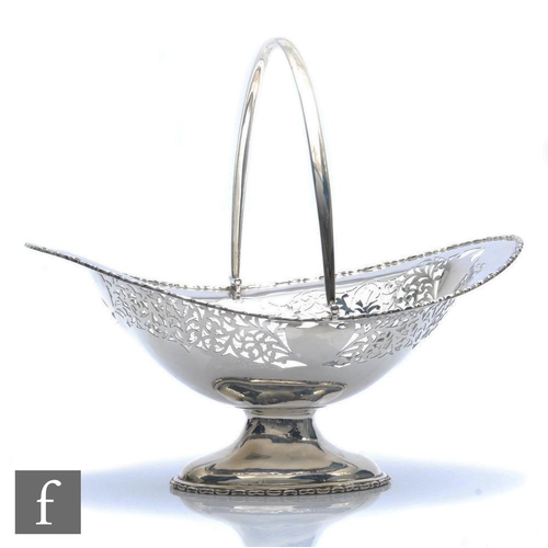 260 - A hallmarked silver oval pedestal swing basket with part pierced decoration, weight 17oz, length 28c... 