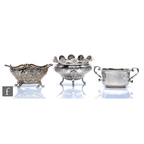 270 - A hallmarked silver twin handled bowl raised on four scroll feet, with a similar sugar basin, total ... 