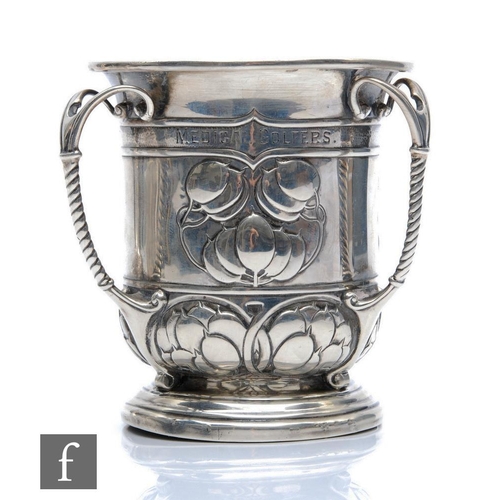 279 - An Arts and Crafts hallmarked silver tyg part decorated with berries and terminating in three ribbed... 