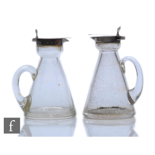 280 - Two hallmarked silver and clear glass toddy jugs of typical form, each with silver collar and hinged... 